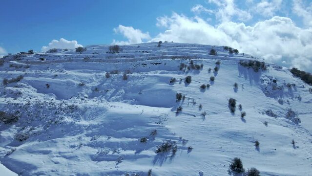Aerial: Drone Forward Shot Of Mount Hermon Covered In Snow On Sunny Day - Majdal Shams, Israel