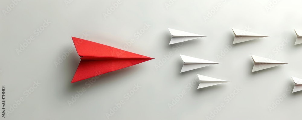 Poster a red paper airplane is flying through a row of white paper airplanes. the red airplane is the only 