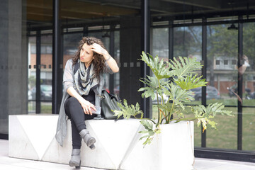 Professional Businesswoman with cell phone. Office woman. Exterior. Latina