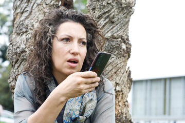 Fototapeta premium Professional Businesswoman Close-Up with cell phone. Office woman. Exterior. Latina