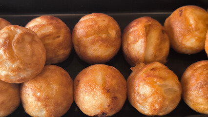 Takoyaki snacks on a black tray, Japanese style food