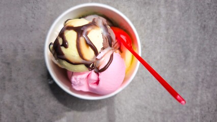 Popsicles in paper cups and red spoons