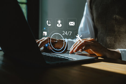 Businessman using laptop with 24 hours servises icon, Customer service, Nonstop service concept.