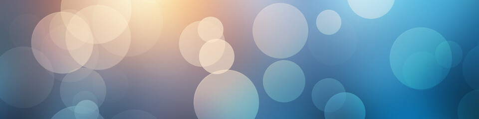 A bokeh blur background in blue with circles. 