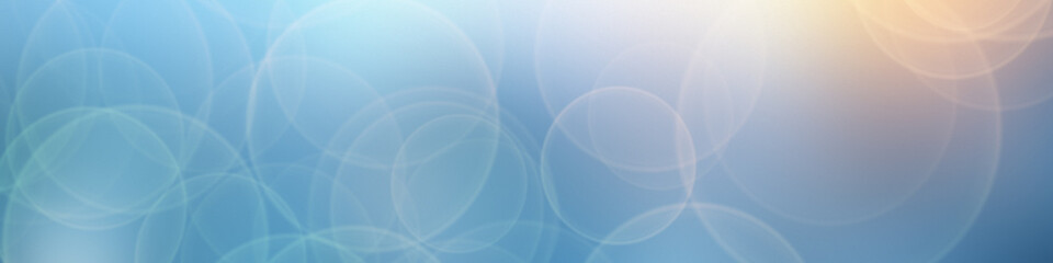 A bokeh blur background in blue with circles. 