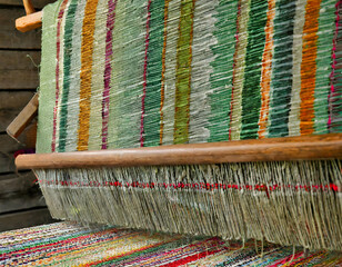 traditional thai carpet.a hand-woven rug on a traditional loom, incorporating playful elements and fantastical details in the weaving process