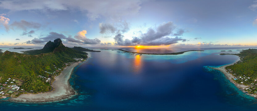 Aerial view of Bora Bora including Mount Otemanu at sunrise in French Polynesia. The tropical island is in the South Pacific ocean near Tahiti. 
