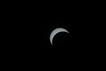 Total eclipse waxing as moon begins to cover the sun