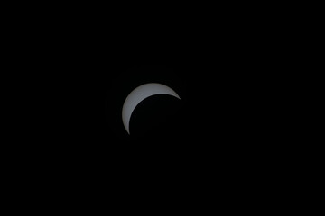 Total eclipse waxing as moon begins to cover the sun