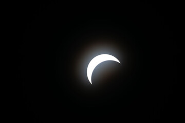 Total eclipse waxing as moon begins to cover the sun