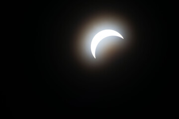 Total eclipse waxing as moon begins to cover the sun