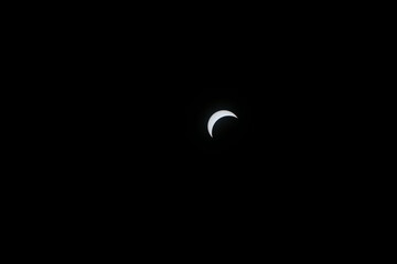 Total eclipse waxing as moon begins to cover the sun