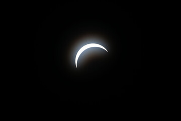 Total eclipse waxing as moon begins to cover the sun
