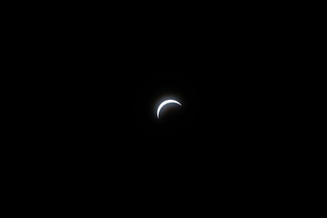 Total eclipse waxing as moon begins to cover the sun