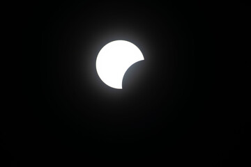 Total eclipse waxing as moon begins to cover the sun
