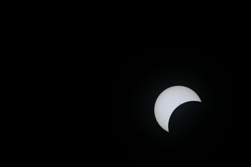 Total eclipse waxing as moon begins to cover the sun