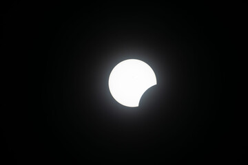 Total eclipse waxing as moon begins to cover the sun