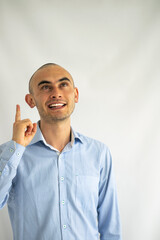 Businessman having an idea. Boy in blue shirt pointing up. Eureka