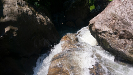 The flow of river water with large rocks looks natural from the upstream of the river