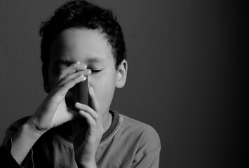 child with flu and inhaler respiratory puff on grey background with people stock photo	