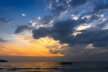 Beautiful coastline tropical beach with palm tree and beautiful colorful sky above the ocean at sunset. Summer vacation in tropical paradise 