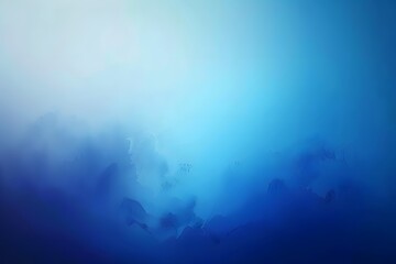 Fototapeta premium Abstract blue gradient background with soft misty texture, evoking tranquility and depth.