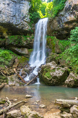 waterfall on a mountain river, the beginning of the spring season , nature walks in the forest