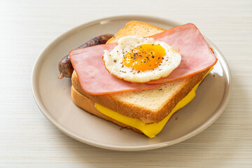 bread toasted cheese topped ham and fried egg with pork sausage