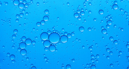 Abstract background of water drops blue bubbles of oil in liquid