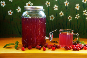 Compote of raspberries and gooseberries on a wooden background