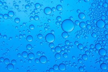 Abstract background of water drops blue bubbles of oil in liquid