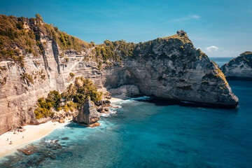 One of the most beautiful travel destination Bali, amazing Diamond Beach Bali with crystal clear azure sea water and scenery mountain rocks in ocean on nature background Bali Indonesia 4K Aerial view