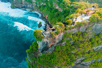 Uluwatu Temple one of six key Bali temple perched on top mountain cliff on nature background Bali, Indonesia 4K Aerial view