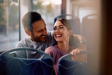 Happy couple enjoying in city bus ride.