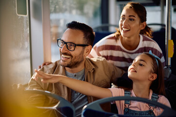 Happy family enjoying in ridding in  bus.