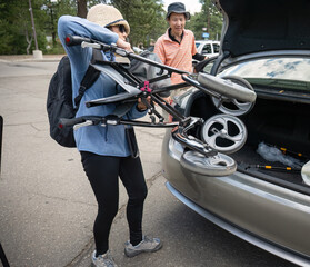Woman putting mobility walker in the car boot. Lake Tahoe. California.