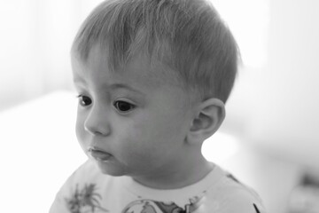 Portrait of a cute baby boy with black eyes