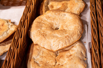fresh hot unleavened flatbreads in a woven basket in a bakery