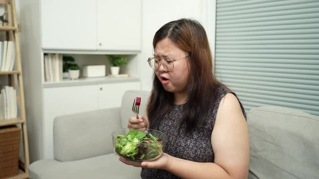 Asian Overweight woman dieting Weight loss eating fresh fresh homemade salad healthy eating concept Obese Woman with weight diet lifestyle.
