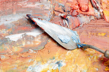 Spatula on oil paints. Close-up