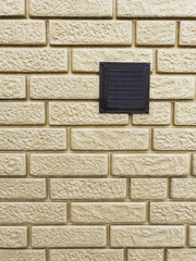 Ventilation hood on a brick wall of a house