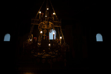 Interior of Temple. Chandelier with candles. Orthodox Church inside.