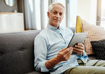 Fototapeta premium Senior man, portrait and tablet in home for typing email, communication and check online news. Elderly person, retirement and relax on sofa in lounge for bills payment, webinar and reading ebook