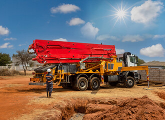 concrete pump crane, concrete pumping services truck pouring liquid concrete, african construction...