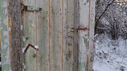 Man opens the door to an old village toilet in winter and shows the toilet hole First person view video