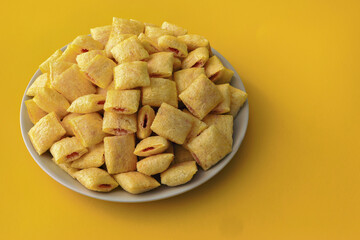 Cookies - corn cushions with strawberry flavored filling on a plate
