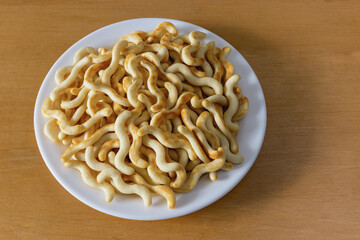 Crispy organic mini crackers in a plate on the table