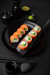 Philadelphia Classic Roll.Sushi composition on black background. The Art of Japanese Cuisine. Food photography for menu and sushi bar decoration