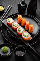 Philadelphia Classic Roll.Sushi composition on black background. The Art of Japanese Cuisine. Food photography for menu and sushi bar decoration