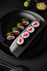 Tuna Maki. Sushi composition on black background. The Art of Japanese Cuisine. Food photography for menu and sushi bar decoration
